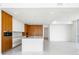 Spacious modern kitchen featuring wood accents, sleek appliances, and a large center island at 111 Golden Gate Pt # 602, Sarasota, FL 34236