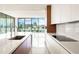 Modern kitchen featuring a large island, sleek white cabinetry, and city views at 111 Golden Gate Pt # 602, Sarasota, FL 34236
