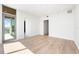 Bright, modern living room with hardwood floors and access to an outdoor balcony at 111 Golden Gate Pt # 602, Sarasota, FL 34236