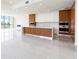 Bright and airy living room featuring a modern kitchen, fireplace, expansive tile flooring, and a captivating city view at 111 Golden Gate Pt # 602, Sarasota, FL 34236