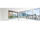 Bright, open living space with floor-to-ceiling windows offering city views at 111 Golden Gate Pt # 602, Sarasota, FL 34236
