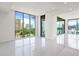 Bright and airy living room with floor-to-ceiling windows offering panoramic city views and tile floors at 111 Golden Gate Pt # 602, Sarasota, FL 34236