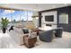 Modern living room with floor-to-ceiling windows, fireplace and beautiful views at 111 Golden Gate Pt # 602, Sarasota, FL 34236