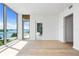 Light-filled living room with hardwood floors and access to a modern bathroom at 111 Golden Gate Pt # 602, Sarasota, FL 34236