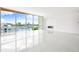 Bright, open living space with a modern fireplace and expansive waterfront views at 111 Golden Gate Pt # 602, Sarasota, FL 34236