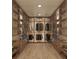 Custom walk-in closet with built-in shelving, drawers, and hanging space for organized storage at 111 Golden Gate Pt # 602, Sarasota, FL 34236