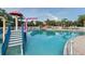 Refreshing community pool with water features and a playground nearby at 12547 Natureview Cir, Bradenton, FL 34212