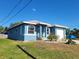Blue house with a white garage door and landscaping at 1308 72Nd E St, Palmetto, FL 34221