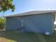 Rear view of a blue house with a back door and yard at 1308 72Nd E St, Palmetto, FL 34221