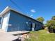 Side view of a blue house with a garage and yard at 1308 72Nd E St, Palmetto, FL 34221