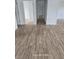 Freshly painted hallway with new wood flooring that leads to a bright white door in the renovated house at 1308 72Nd E St, Palmetto, FL 34221