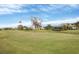 View of a beautiful golf course with homes in the background at 1420 Turnberry Dr, Venice, FL 34292