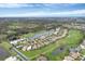 Community overview with houses, golf course and lake at 1420 Turnberry Dr, Venice, FL 34292