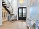 Grand entryway with double doors, a modern staircase, and elegant decor at 1516 S Orange Ave, Sarasota, FL 34239