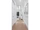 Light and bright hallway with white walls, wood floors, and recessed lighting at 1516 S Orange Ave, Sarasota, FL 34239