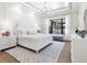 Bright main bedroom with white bedding and a view at 1516 S Orange Ave, Sarasota, FL 34239