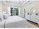 Main bedroom with white bedding and access to backyard at 1516 S Orange Ave, Sarasota, FL 34239