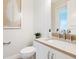 Modern powder room with beige countertop and white cabinets at 1516 S Orange Ave, Sarasota, FL 34239