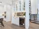 Custom wet bar with wine fridge and glass-front cabinets at 1516 S Orange Ave, Sarasota, FL 34239