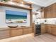 Wet bar with wood cabinets, wine cooler, and TV at 1516 S Orange Ave, Sarasota, FL 34239