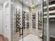 Elegant wine cellar with glass walls, herringbone flooring, and ample wine storage at 1516 S Orange Ave, Sarasota, FL 34239