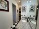 Bathroom featuring light granite counter, dark wood vanity and checkered floors at 15618 Castle Park Ter, Lakewood Ranch, FL 34202