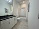 Clean bathroom featuring a granite countertop, white cabinets, and a shower-tub combo at 15618 Castle Park Ter, Lakewood Ranch, FL 34202