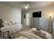 Bright bedroom features two twin beds, a television, and neutral decor at 15618 Castle Park Ter, Lakewood Ranch, FL 34202