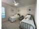 Nautical themed bedroom with two twin beds and decorative compasses on the wall at 15618 Castle Park Ter, Lakewood Ranch, FL 34202