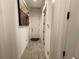 Neutral hallway featuring a decorative art piece and sleek wood-style flooring at 15618 Castle Park Ter, Lakewood Ranch, FL 34202