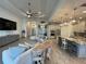 Open-concept living room with modern kitchen featuring stainless steel appliances and granite counters at 15618 Castle Park Ter, Lakewood Ranch, FL 34202