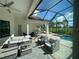 Relaxing screened patio with comfortable furniture, a pool, and a great golf course view at 15618 Castle Park Ter, Lakewood Ranch, FL 34202