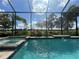Relaxing pool view with lush landscaping and screen enclosure for ultimate privacy at 15618 Castle Park Ter, Lakewood Ranch, FL 34202