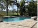Screened in pool with brick patio, golf course view and lush tropical landscaping at 15618 Castle Park Ter, Lakewood Ranch, FL 34202