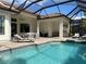 Exterior pool area with covered outdoor seating and entertainment area and outdoor stainless steel grill at 15618 Castle Park Ter, Lakewood Ranch, FL 34202