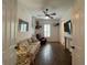 Sitting room featuring wood floors, a ceiling fan, and comfortable furnishings at 15618 Castle Park Ter, Lakewood Ranch, FL 34202