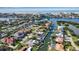 Stunning aerial view of waterfront home, pool, lush landscaping, and canal access to Gulf of Mexico at 1649 Stanford Ln, Sarasota, FL 34231