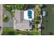 Aerial view showcasing home with pool, boat dock, lush green lawn, and driveway at 1649 Stanford Ln, Sarasota, FL 34231