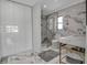 Modern bathroom featuring marble tile, glass shower, and sleek fixtures at 1649 Stanford Ln, Sarasota, FL 34231