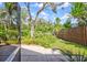 Private backyard with lush landscaping and a wooden fence at 1775 Southwood St, Sarasota, FL 34231