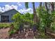 Relaxing backyard patio with seating area, lush landscaping, and privacy fence at 1775 Southwood St, Sarasota, FL 34231