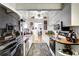 Galley kitchen with white cabinets, wood countertops, and black appliances at 1775 Southwood St, Sarasota, FL 34231