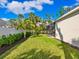 Landscaped backyard with lush greenery and a grassy lawn at 1827 Morris St, Sarasota, FL 34239