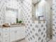 Bathroom with palm tree wallpaper and a walk-in shower at 1827 Morris St, Sarasota, FL 34239