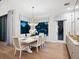 Elegant dining room with a large table, chandelier, and access to backyard at 1827 Morris St, Sarasota, FL 34239