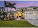 Two-story house featuring a walkway, landscaping, and three-car garage at 1827 Morris St, Sarasota, FL 34239