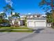 Two-story house with white siding, white garage doors, and landscaping at 1827 Morris St, Sarasota, FL 34239