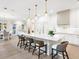 Large kitchen island with seating, white cabinets, and stainless steel appliances at 1827 Morris St, Sarasota, FL 34239