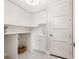 Bright laundry room with ample cabinet space and a utility sink at 1827 Morris St, Sarasota, FL 34239