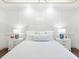 Serene main bedroom with white bedding and elegant wall paneling at 1827 Morris St, Sarasota, FL 34239